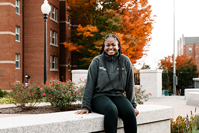 Student sitting outside on campus