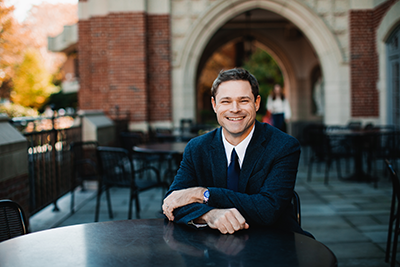 Professor poses on Ruane patio