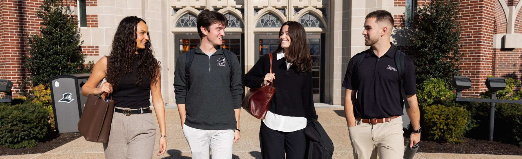 Graduate Students walking out of Providence College Admissions building.